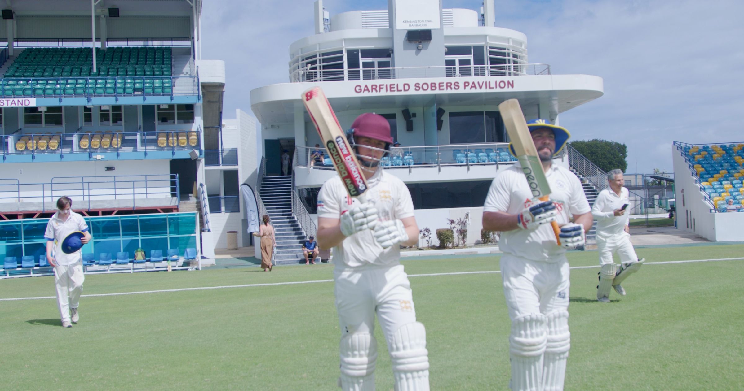Two batters walk out in front of the Garfield Sobers Pavilion at Kensington Oval, Barbados